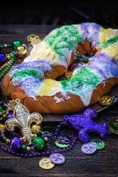King cake surrounded by mardi gras decorations Stock Photos