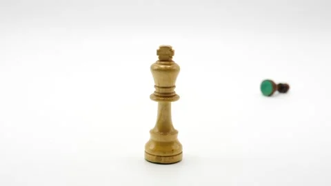 King chest piece being knocked down by falling chess pieces isolated and white Stock Footage 218081553