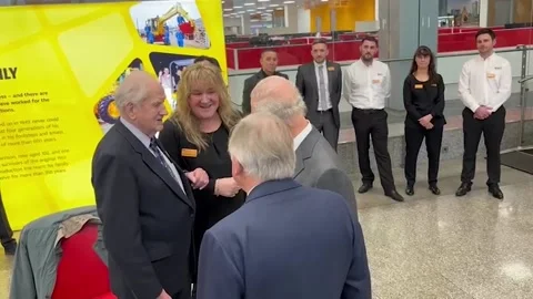 King greeted by cheering crowds at JCB headquarters in Staffordshire Video stock 302823423