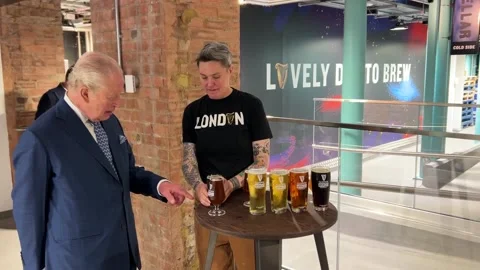 King pulls ‘perfect’ pint of Guinness at new London brewery opening Stock Footage 324106592