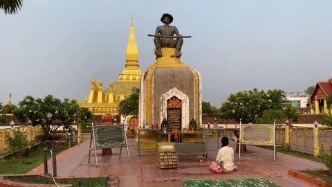 King Setthathirath statue and Wat That Luang temple, Vientiane, Laos 4K Stock Footage 274700543