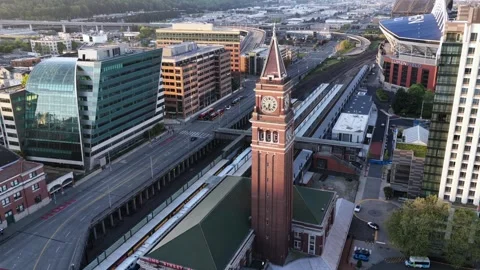King Street Station clock tower rises beside elevated rail lines, Lumen Field Видео 337513990
