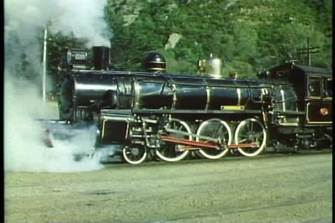 Kingston Flyer, New Zealand steam locomotive and train, medium shot, pulling out Stock Footage