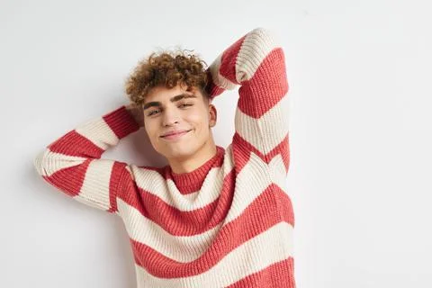 Kinky guy in a striped sweater posing light background Stock Photos
