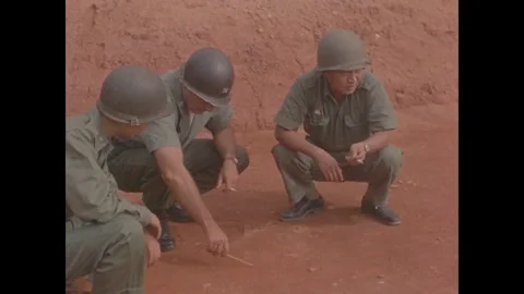 KINMEN - 1958: Men crouch to sketch in the earth 動画素材 342670306