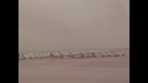 KINMEN - 1958: Rail obstacles line a tidal beach Stock Footage 342670271