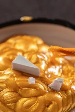 Kintsugi concept. Gold glue to join broken ceramics. Photos