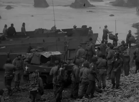 KISKA, ALASKA - 1943: Field force - Troops gather among crates and tarps Stock Footage 343788333