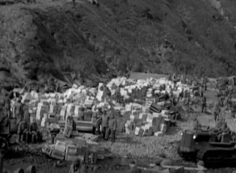 KISKA, ALASKA - 1943: Supply dump — crates stacked below a bare bluff Vidéo 343135420