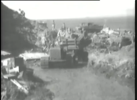 KISKA, ALASKA - 1943: Supply dump - Tracked machine works among crates Stock-Footage 343786865