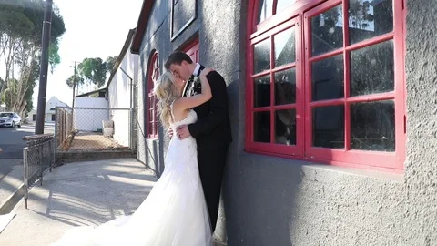 Kiss next to a Red Window Frame Stock-Footage 114885396