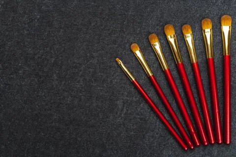 Kit of makeup brushes in red coating Stock Photos