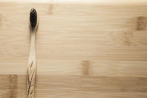 Kit of toothbrushes on the rustic wooden table in the bathroom. Warm and welc Stock Photos