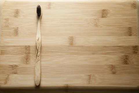 Kit of toothbrushes on the rustic wooden table in the bathroom. Warm and welc Stock Photos