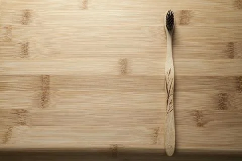Kit of toothbrushes on the rustic wooden table in the bathroom. Warm and welc Stock Photos