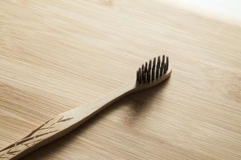 Kit of toothbrushes on the rustic wooden table in the bathroom. Warm and welc Stock Photos