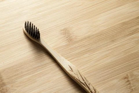 Kit of toothbrushes on the rustic wooden table in the bathroom. Warm and welc Stock Photos