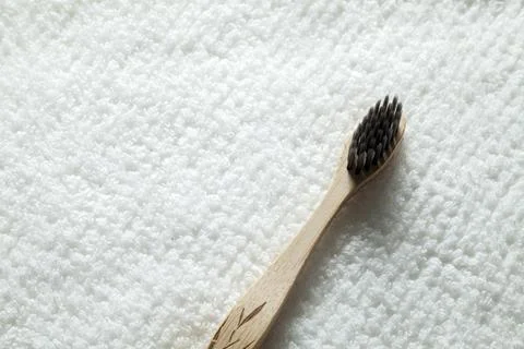 Kit of toothbrushes on the rustic wooden table in the bathroom. Warm and welc Stock Photos