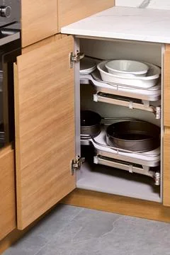 Kitchen access mechanism Magic corner for Blind Corner Cabinets pushed inside Stock Photos