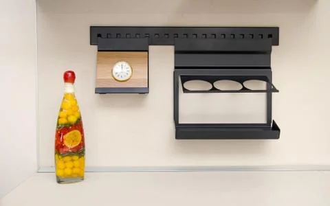 Kitchen accessories in a modern kitchen with a clock and a decorative bottle Foto stock