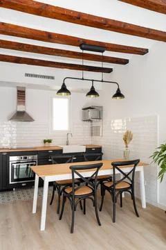Kitchen and dining table with chairs in studio apartment Stock Photos