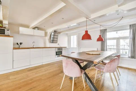 Kitchen and dining zone in modern apartment Stock Photos