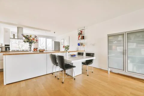 Kitchen and dining zone in studio apartment Stock Photos