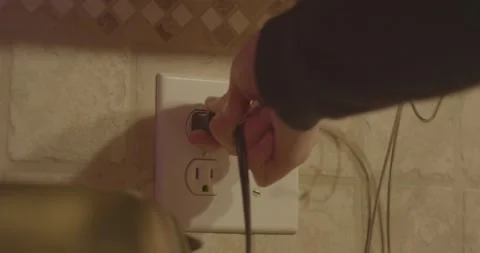 Kitchen appliance being plugged into wall outlet Video stock 233314833