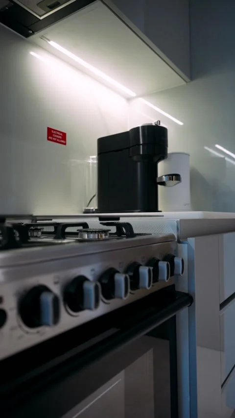 Kitchen area in the apartment with coffee machine, plumbing and washing machine Stock Footage 263233478