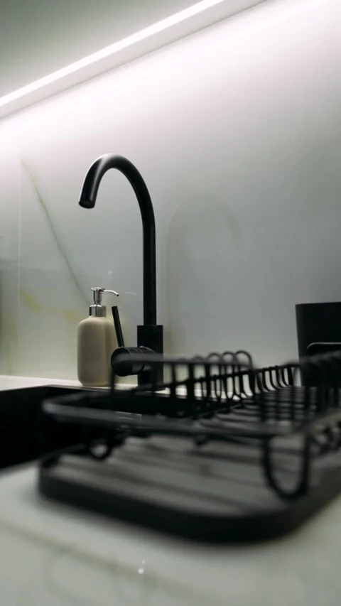 Kitchen area in the apartment with coffee machine, plumbing and washing machine Stock Footage 263233489