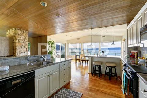 Kitchen area with paneled ceiling and hardwood floor Stock Photos