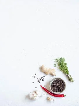 Kitchen background with Garlic, fresh thyme, black pepper, ginger and chili p Stock Photos