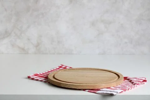 Kitchen background, mockup. an empty cutting board and a checkered red towel Stock-Fotos
