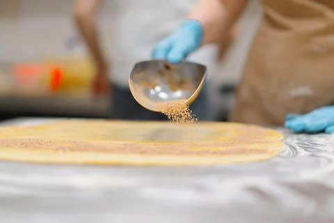 The kitchen in the bakery - the process of making cinnabons, the woman baker 写真素材