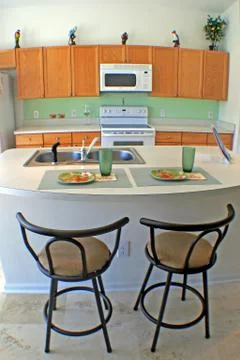 Kitchen with bar stools Stock Photos
