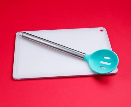 Kitchen board with kitchen spoon on red background. Asian cuisine 스톡 사진