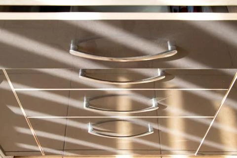 Kitchen brown pull-out drawers with handles in an apartment on the kitchen wi Stock Photos
