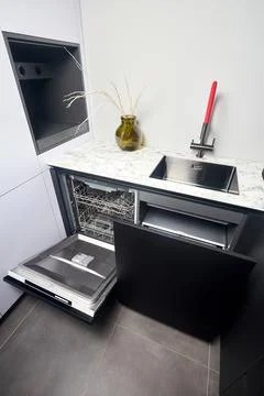 Kitchen with built-in opened dishwasher and pull out drawer for waste bin sep 写真素材