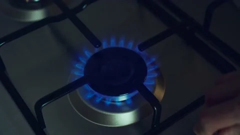Kitchen burner turning on. Stove igniting into blue cooking flame Stock Footage 203840728