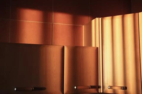 Kitchen cabinets in the rays of the setting sun Stock Photos