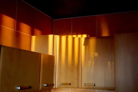 Kitchen cabinets in the rays of the setting sun Stock Photos