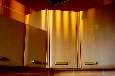 Kitchen cabinets in the rays of the setting sun Stock Photos