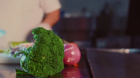 Kitchen chef cutting cucumber with a knife. Zoom in shoot Stock Footage 104195871
