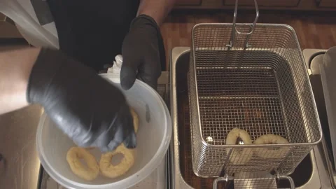 Kitchen chef preparing a dish of fried breaded cuttlefish. (C) Stock Footage 165464383