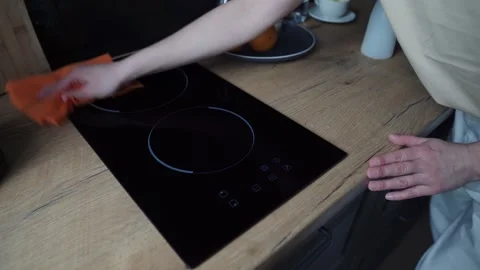 Kitchen cleaning. Close-up. Cleaning of the apartment. A woman's hand wipes an Stock Footage 255984863