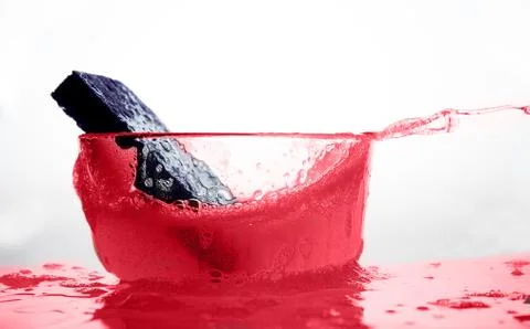 Kitchen cleaning Sponge in Glass of Soapy Water Stock Photos