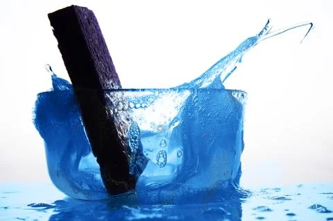 Kitchen cleaning Sponge in Glass of Soapy Water Stock Photos