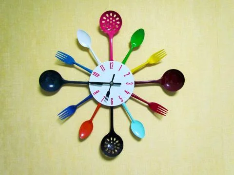 Kitchen clock made with plastic tableware Stock Photos
