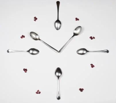 Kitchen clock made with teaspoons and beans. Stock Photos