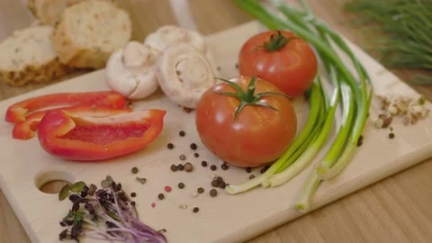On kitchen close up vegetables on a wooden board. Tomato onion microgreen. Fresh Stock Footage 144960601